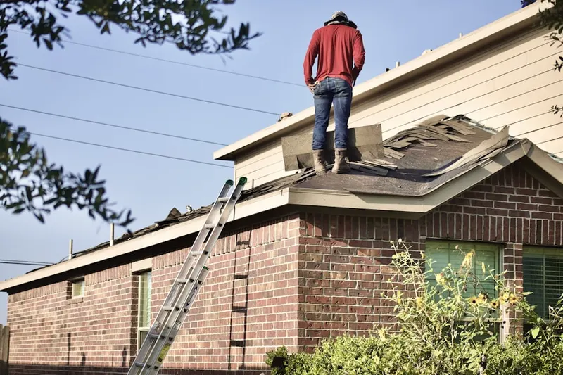 Professional roofer working on a residential roof in Buford